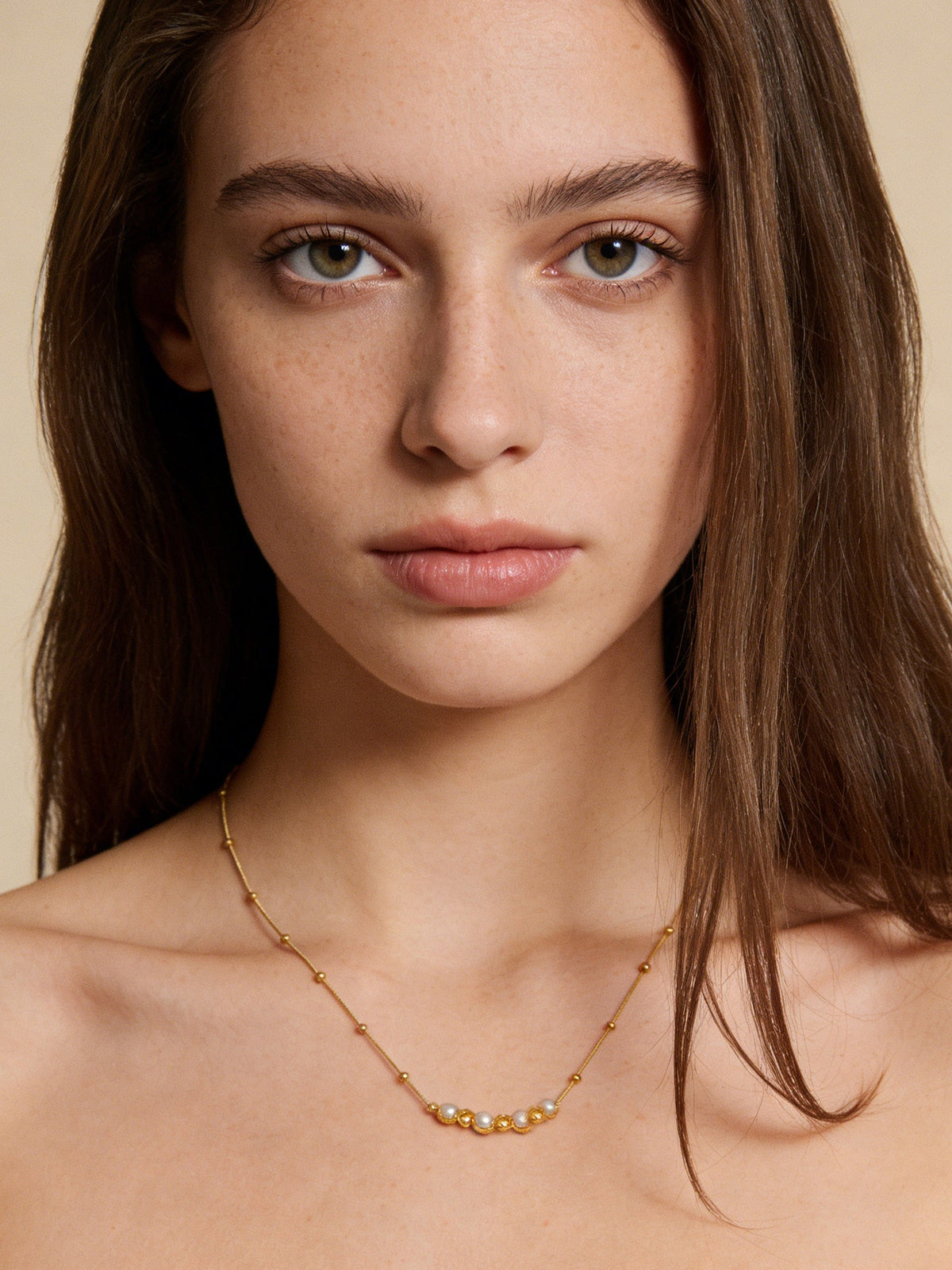 Accent Beaded Choker Necklace in gold with faux pearls, shown on a model, front view