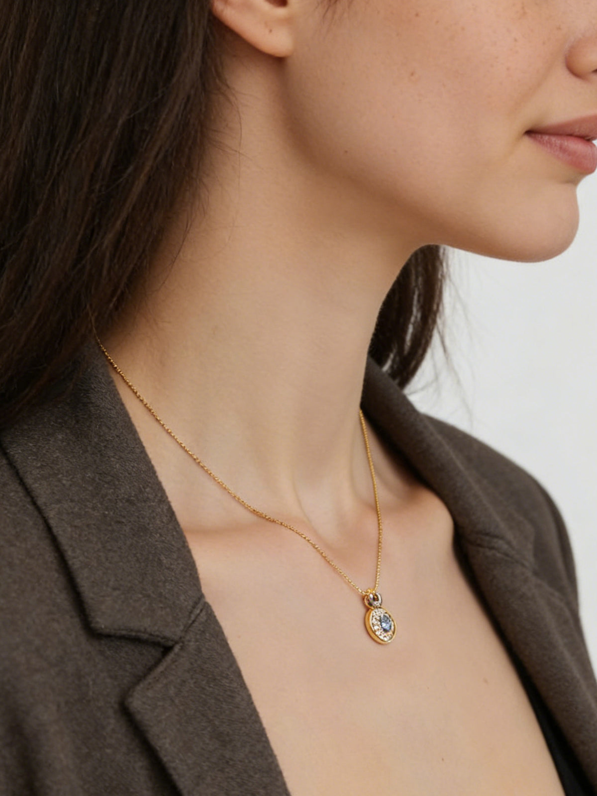 Bright Free Sky Necklace in gold, shown on a model facing right, medium view