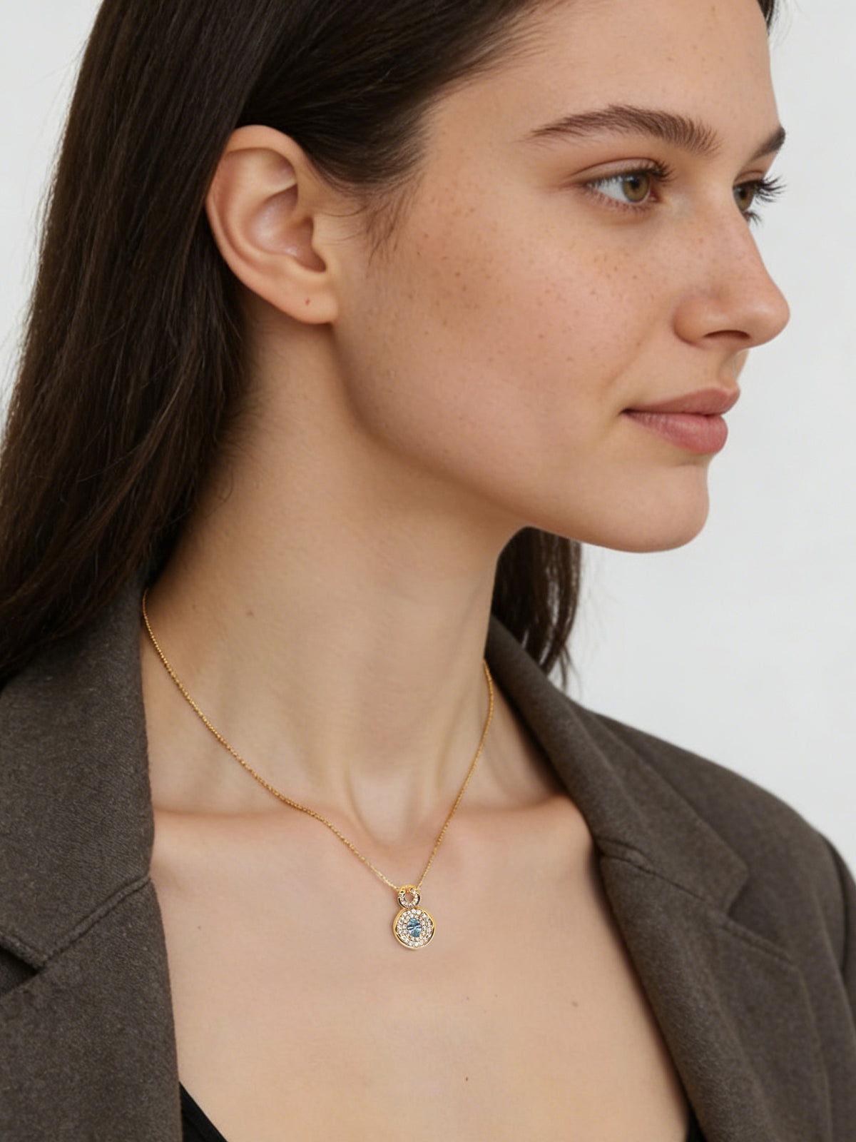Bright Free Sky Necklace in gold, shown on a model facing right, wide view