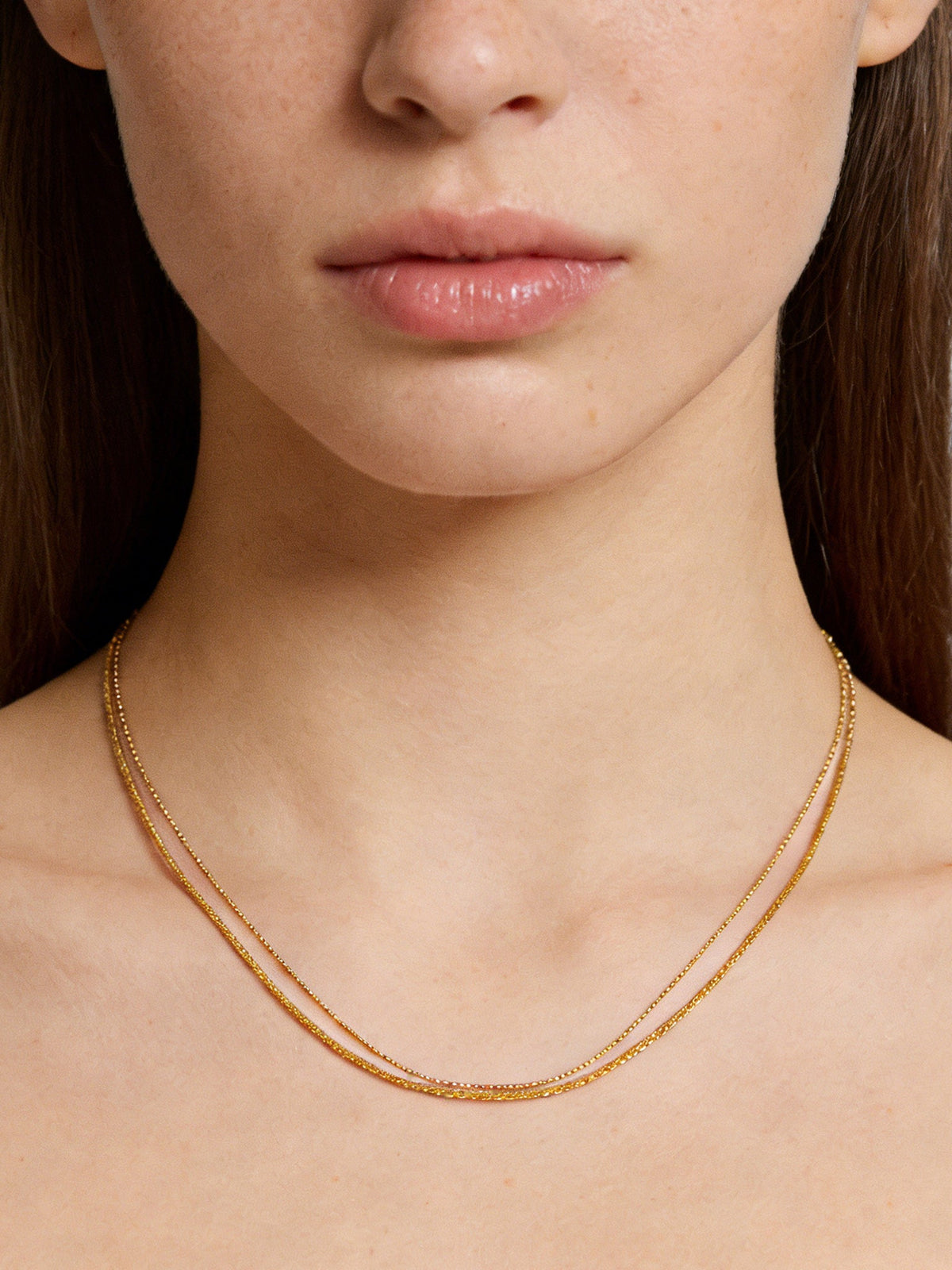 Double-Layered Choker Necklace in gold, shown on a model, close-up front view