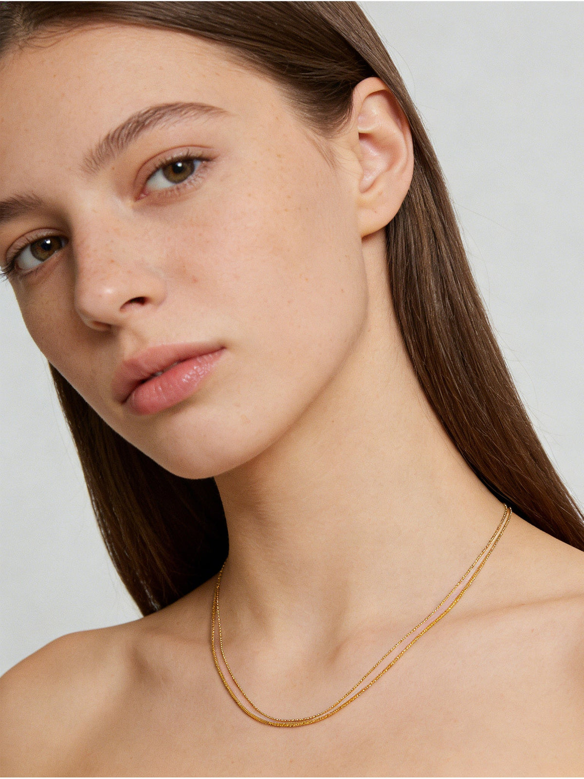 Double-Layered Choker Necklace in gold, shown on a model, three-quarter view