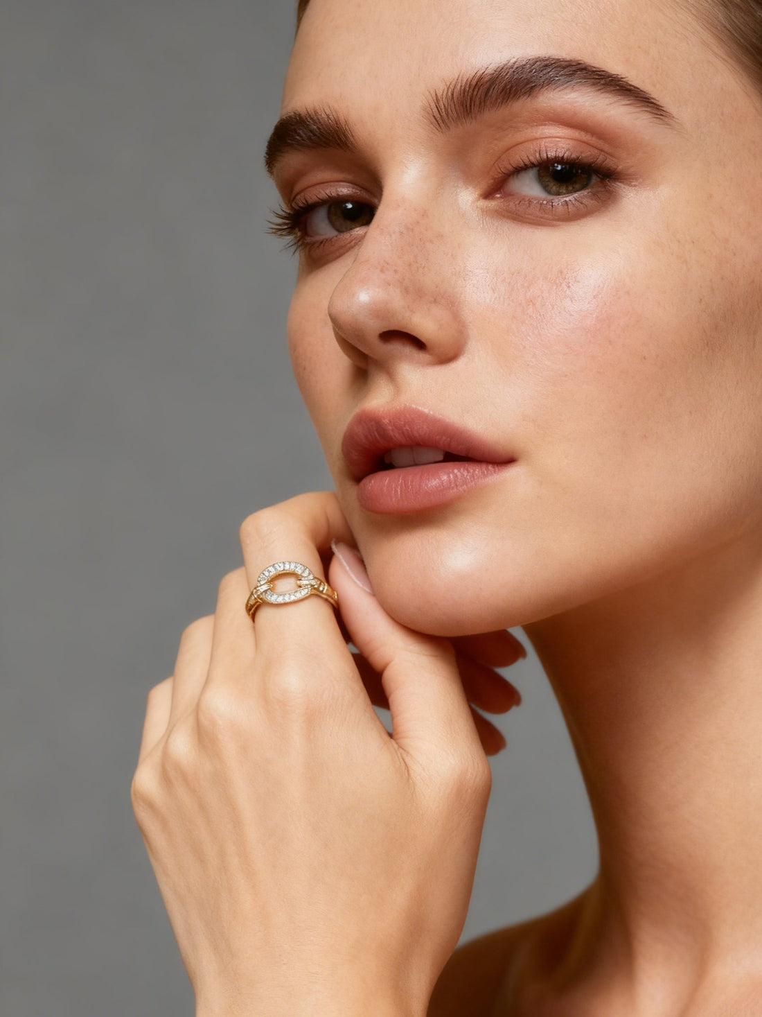 Heart Rhythm Ring in gold with clear stones, on a white background, three quarter view