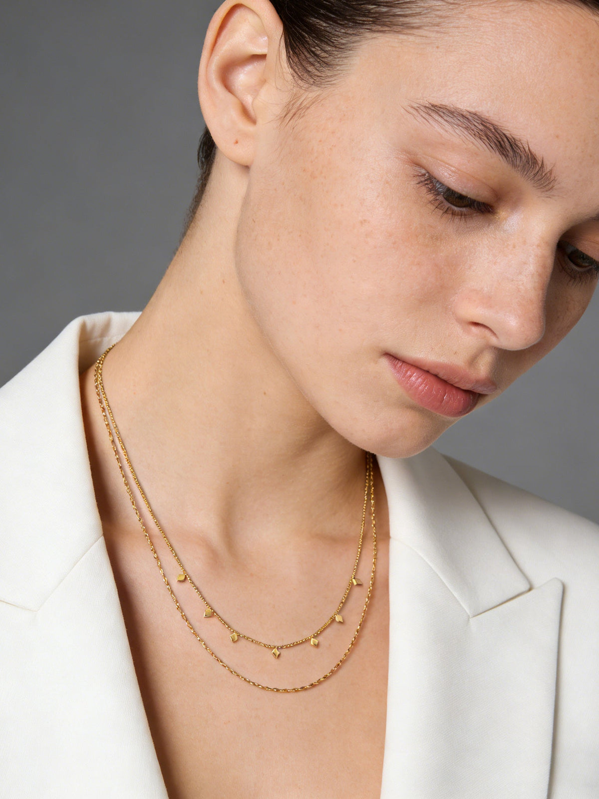 Layered Geo Pendant Necklace in gold, shown on a model looking down