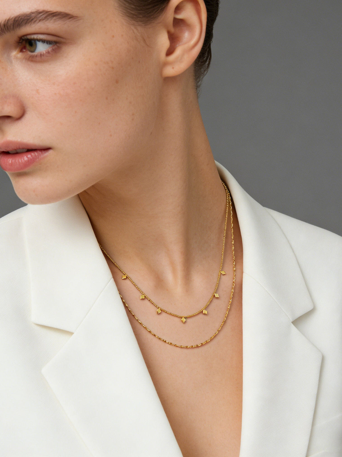 Layered Geo Pendant Necklace in gold, shown on a model, three-quarter left view