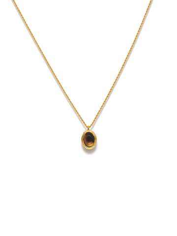 Oval Glow Pendant Necklace in gold with a brown stone, on a white background, pendant close-up