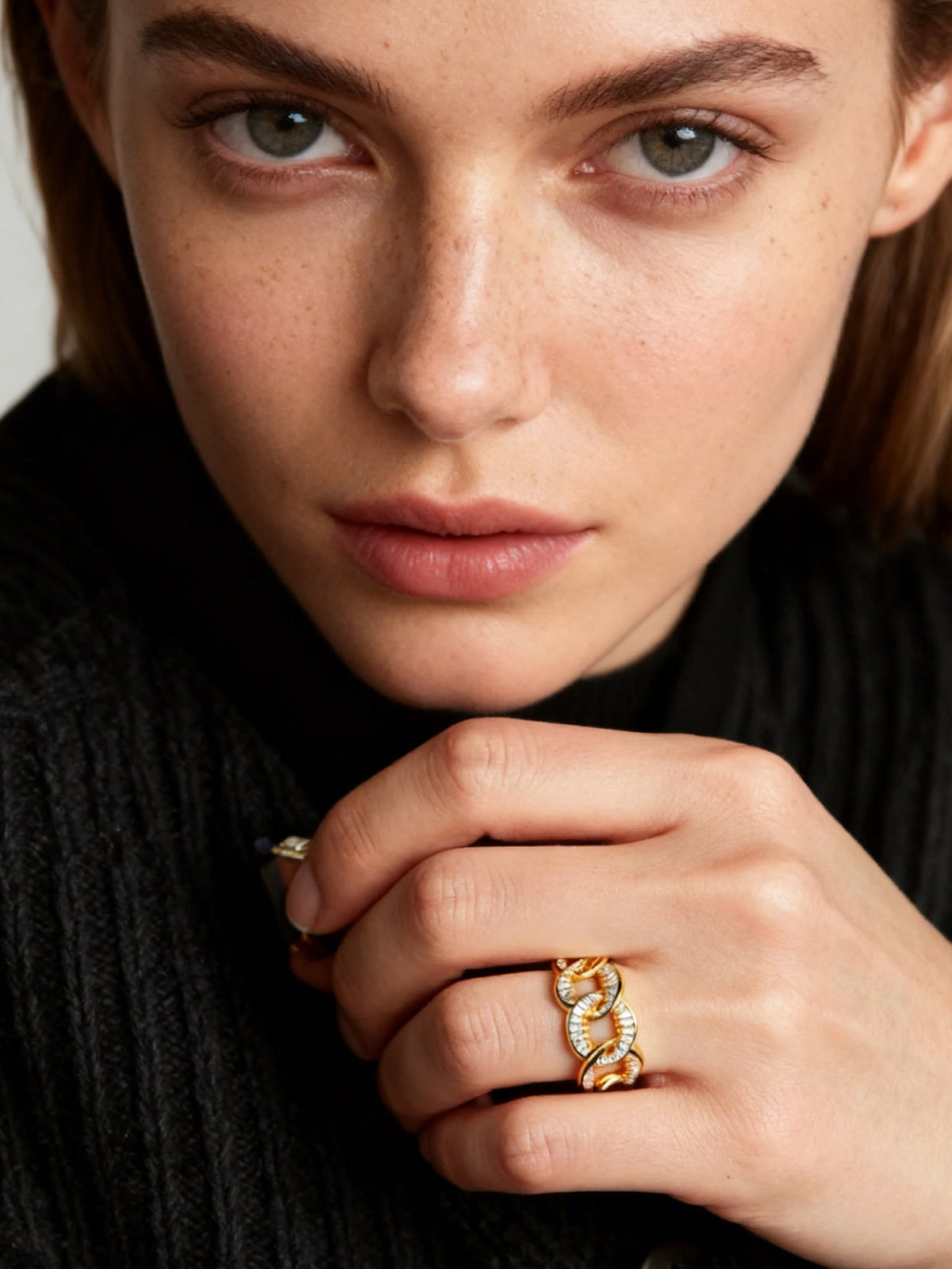 Self-Connection Chain Ring in gold with clear stones, shown on a model, close up