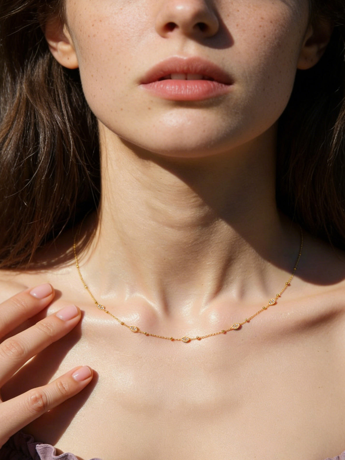 Sparkle Droplet Choker Necklace in gold with clear stones, shown on a model, front close-up