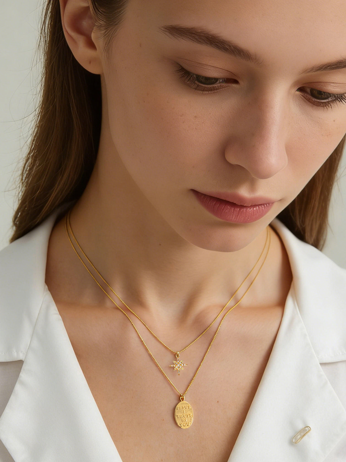 Star and Engraved Layered Necklace in gold, shown on a model looking down, front view