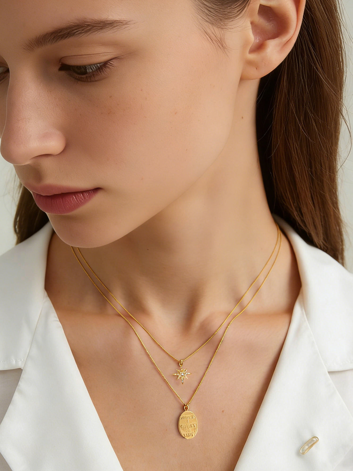 Star and Engraved Layered Necklace in gold, shown on a model looking left