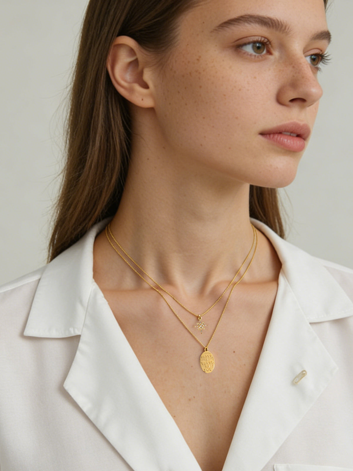 Star and Engraved Layered Necklace in gold, shown on a model facing right, wide view