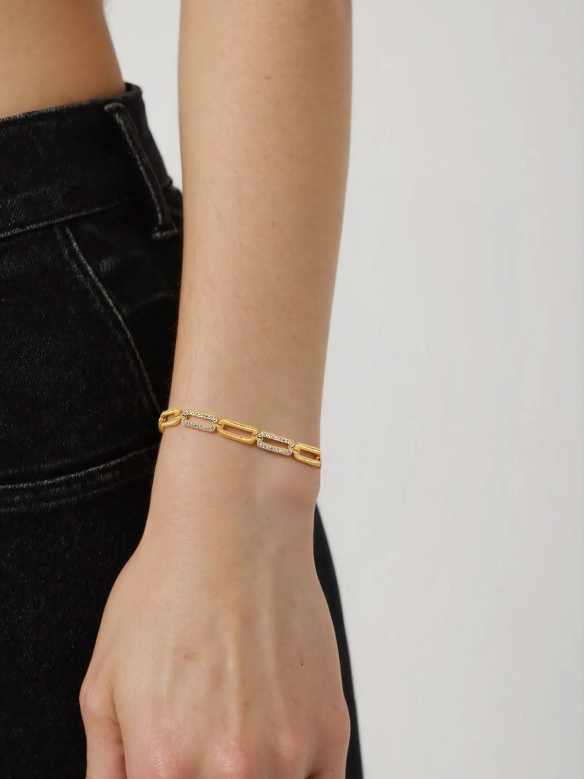 Wrist Sparkle Zircon Link Bracelet in gold with clear zircons, shown on a model, wrist close-up